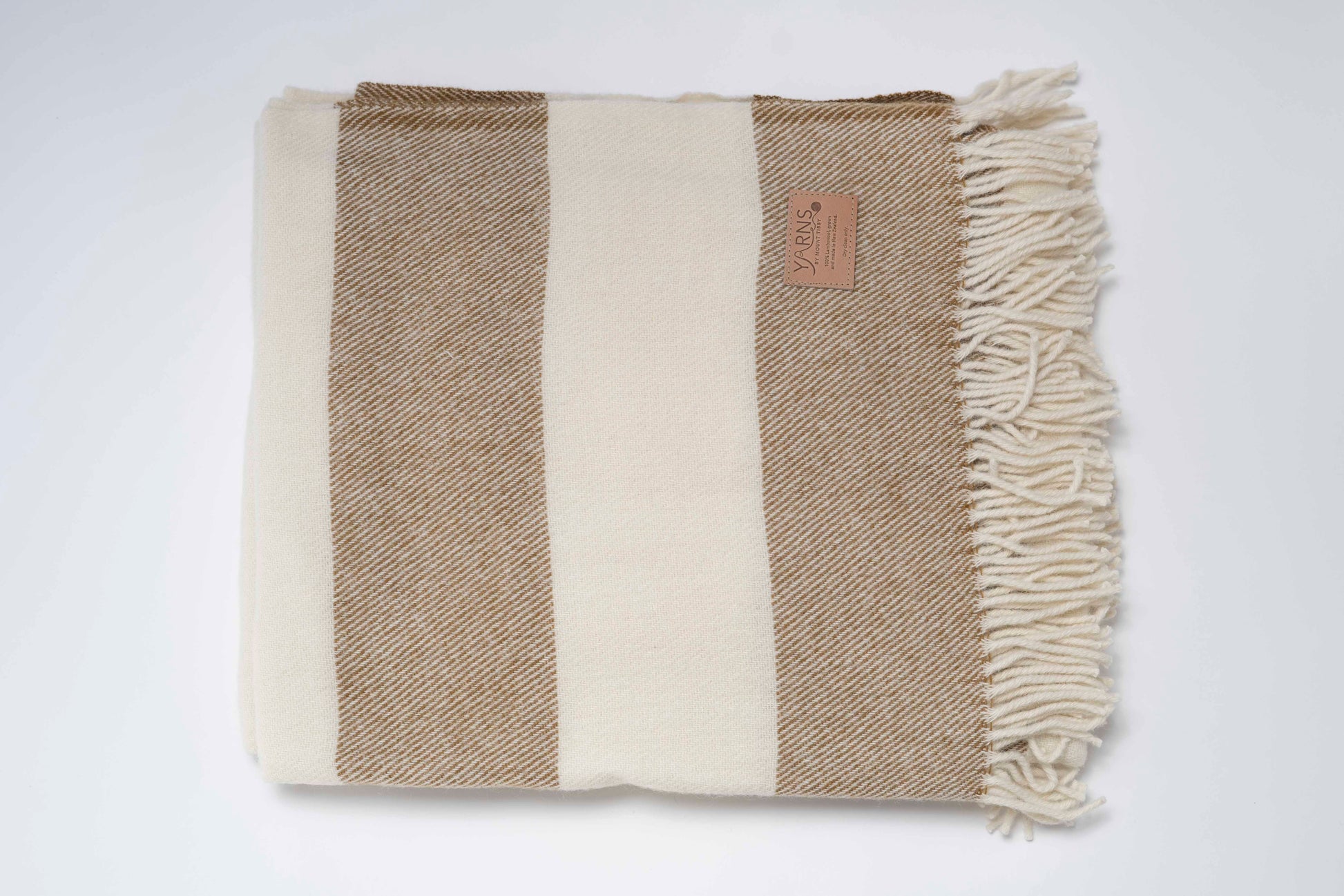 Woven blanket with Clay and white stripes on a white background