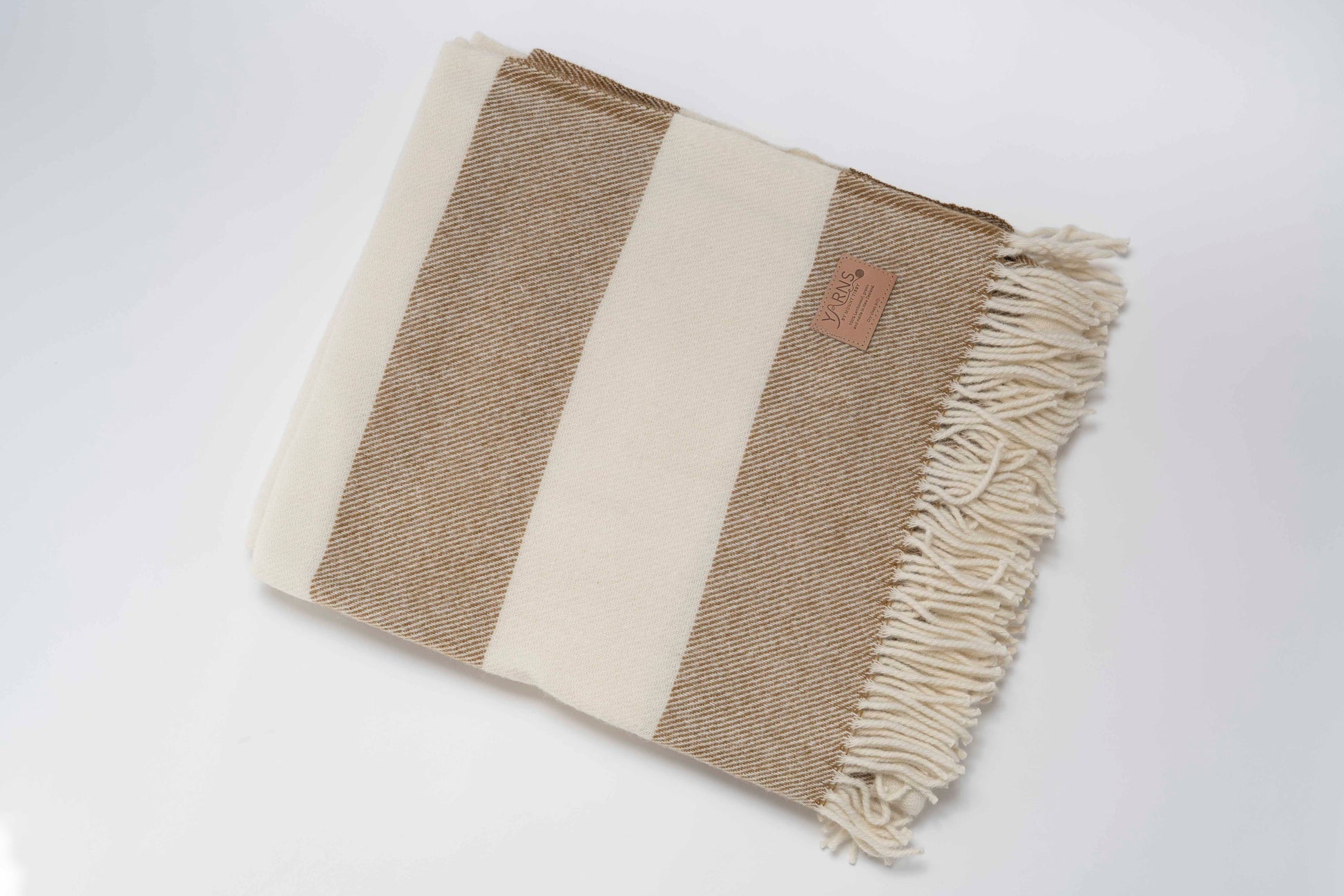 Clay and White striped blanket with fringes on a white background